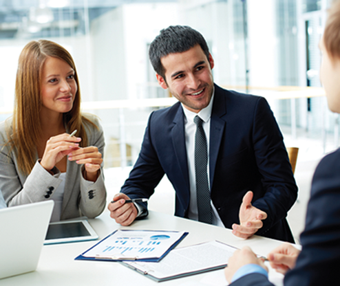 three people having a business meeting smiling